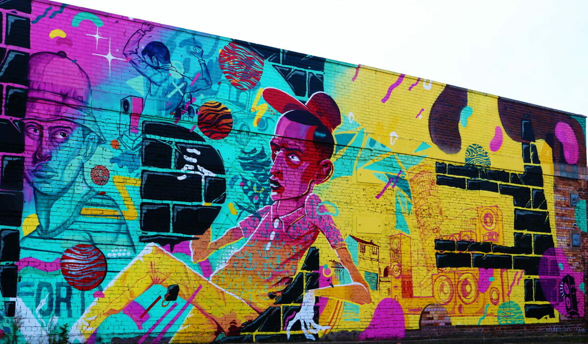 multicolored man sitting themed graffiti art