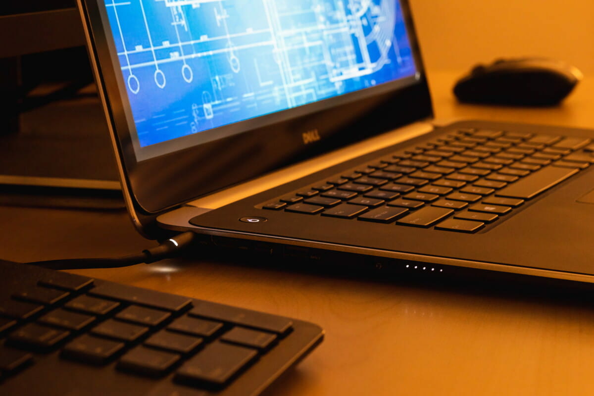 laptop showing technical blueprint drawing with mouse