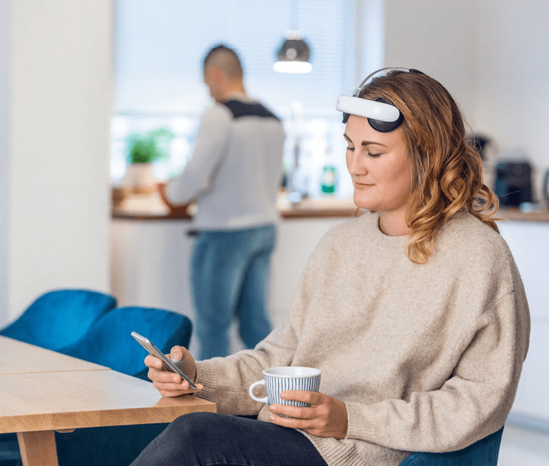 Woman sitting at desk using flow headset