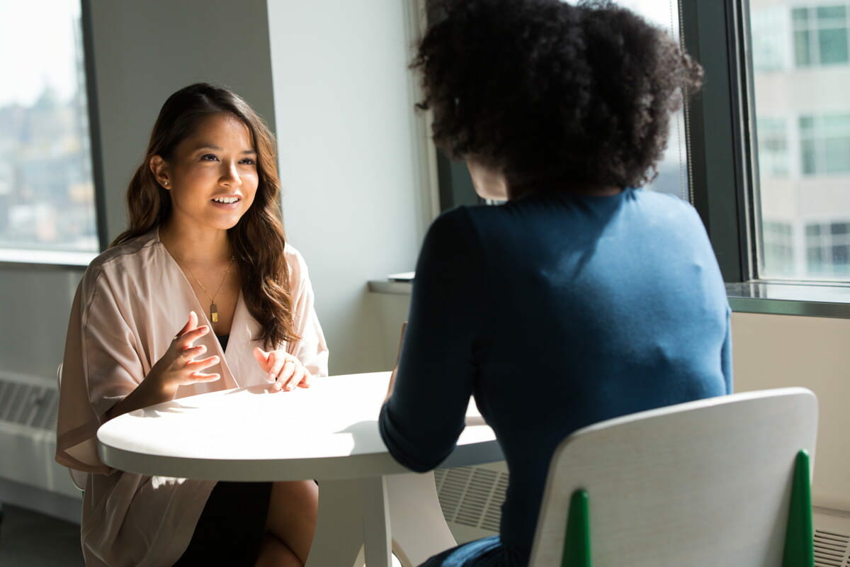 two women sitting on chair.jpg
